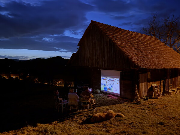 Locals watch the World Cup soccer match between England and Croatia projected on a barn wall, in Kumrovec, northern Croatia, Wednesday, June 17, 2026. (AP Photo/Darko Bandic)