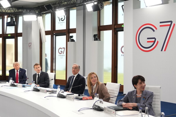 From right, U.S. President Donald Trump, French President Emmanuel Macron, Canadian Prime Minister Mark Carney, Italian Prime Minister Giorgia Meloni and Japan's Prime Minister Sanae Takaichi during a working session at the G7 summit in Evian-les-Bains, France, Wednesday, June 17, 2026. (AP Photo/Thibault Camus)