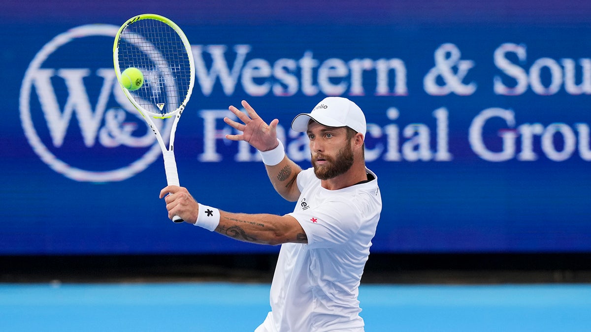 Corentin Moutet returns a shot against Mackenzie McDonald during a tennis match at the Cincinnati Open.