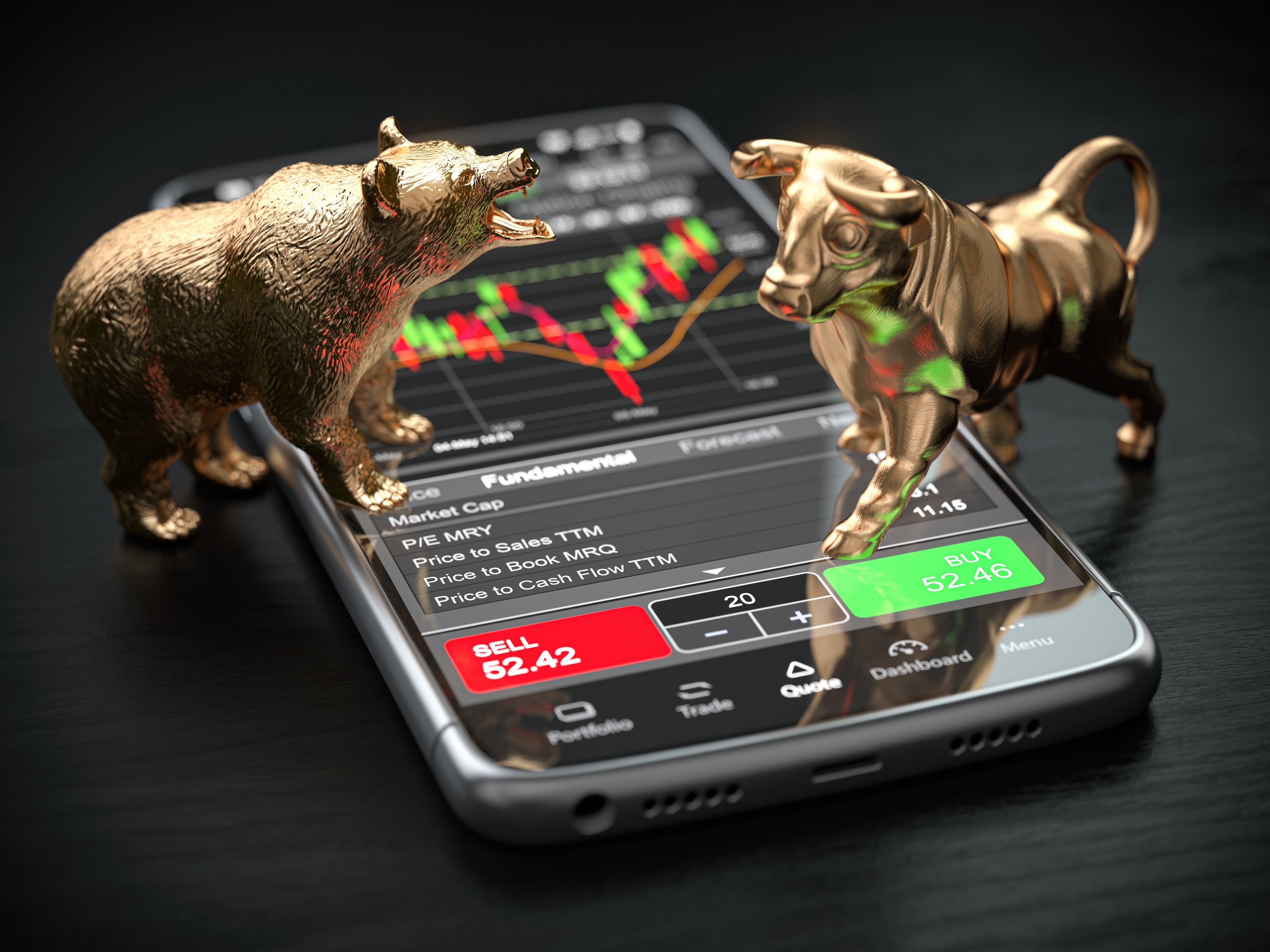 Golden bull and bear figurines stand on top of a smartphone.