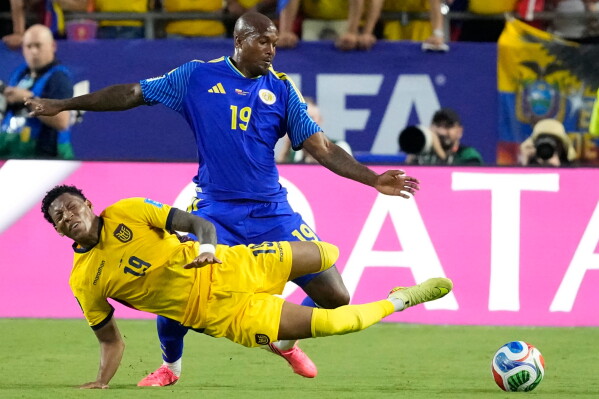 Ecuador's Gonzalo Plata, bottom, falls after being fouled by Curaçao's Gervane Kastaneer during the World Cup Group E soccer match in Kansas City, Mo., Saturday, June 20, 2026. (AP Photo/Charlie Riedel)