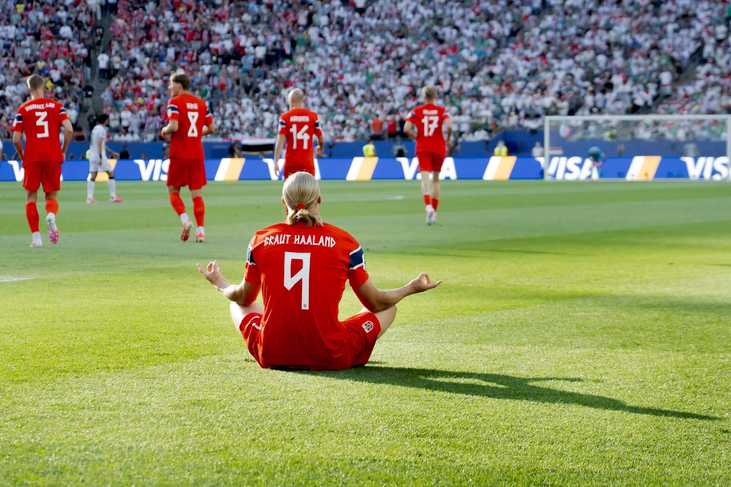 Haaland sitting on the pitch