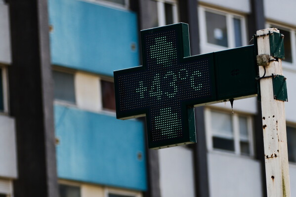 A drugstore sign shows the temperature 43 degrees Celsius (109,4 degrees Fahrenheit) in Rennes, western France, Monday, June 22, 2026. (AP Photo/Jeremias Gonzalez)