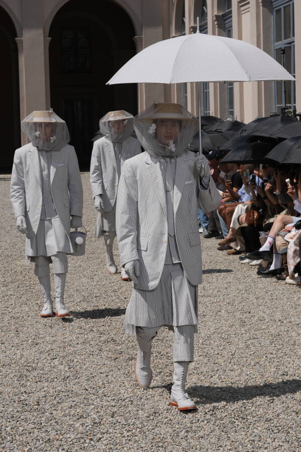 Models wear creations of the Tom Browne Spring/Summer 2027 collection, presented in Milan, Italy, Monday, June 22, 2026. (AP Photo/Antonio Calanni)
