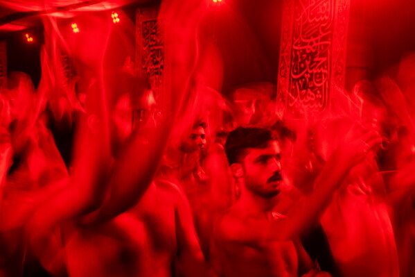 Iraqi Shiite faithful Muslims beat their chests as a sign of grief for Imam Hussein during a Muharram procession in Baghdad, Iraq, Thursday, June 25, 2026. (AP Photo/Adil al-Khazali)