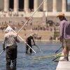 Visitors watch as National Park Service employees use vacuums to clean the Lincoln Memorial Reflecting Pool, Saturday, June 20, 2026, in Washington.