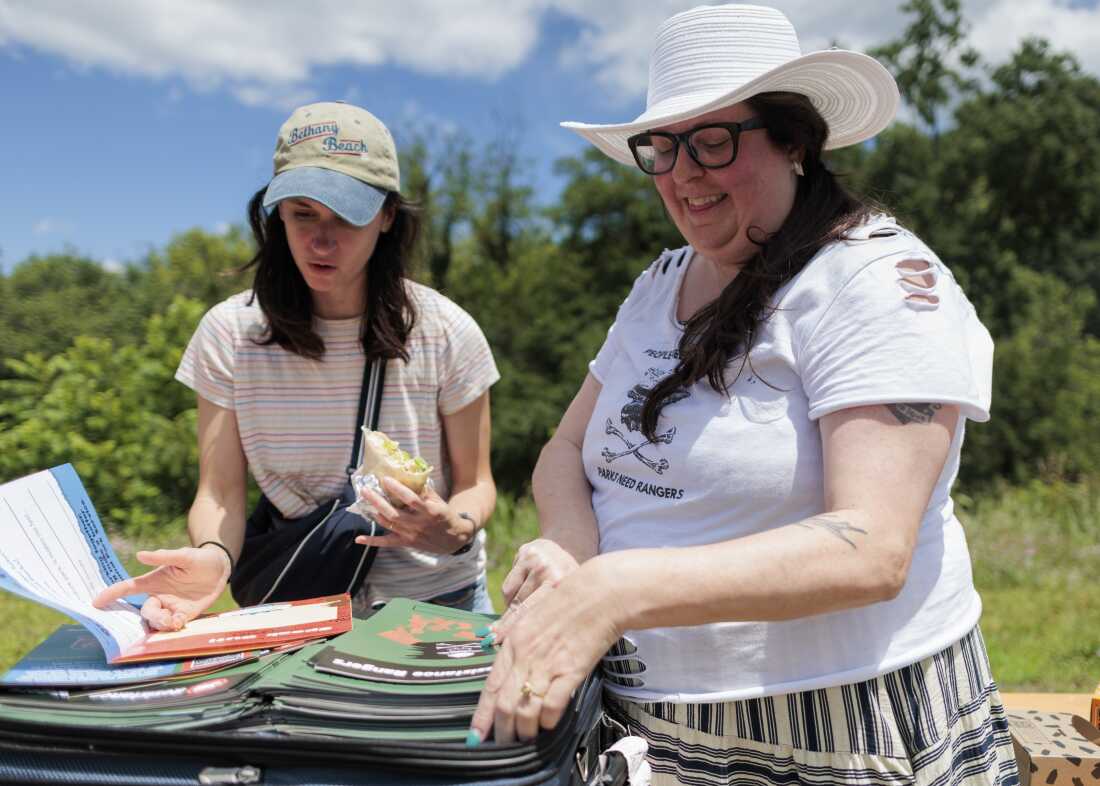 Ella Wagner, 35, and Melissa Dalley, 49, unpack Junior Resistance Ranger booklets for the America 433 pop up event at Harpers Ferry National Historical Park on June 19.