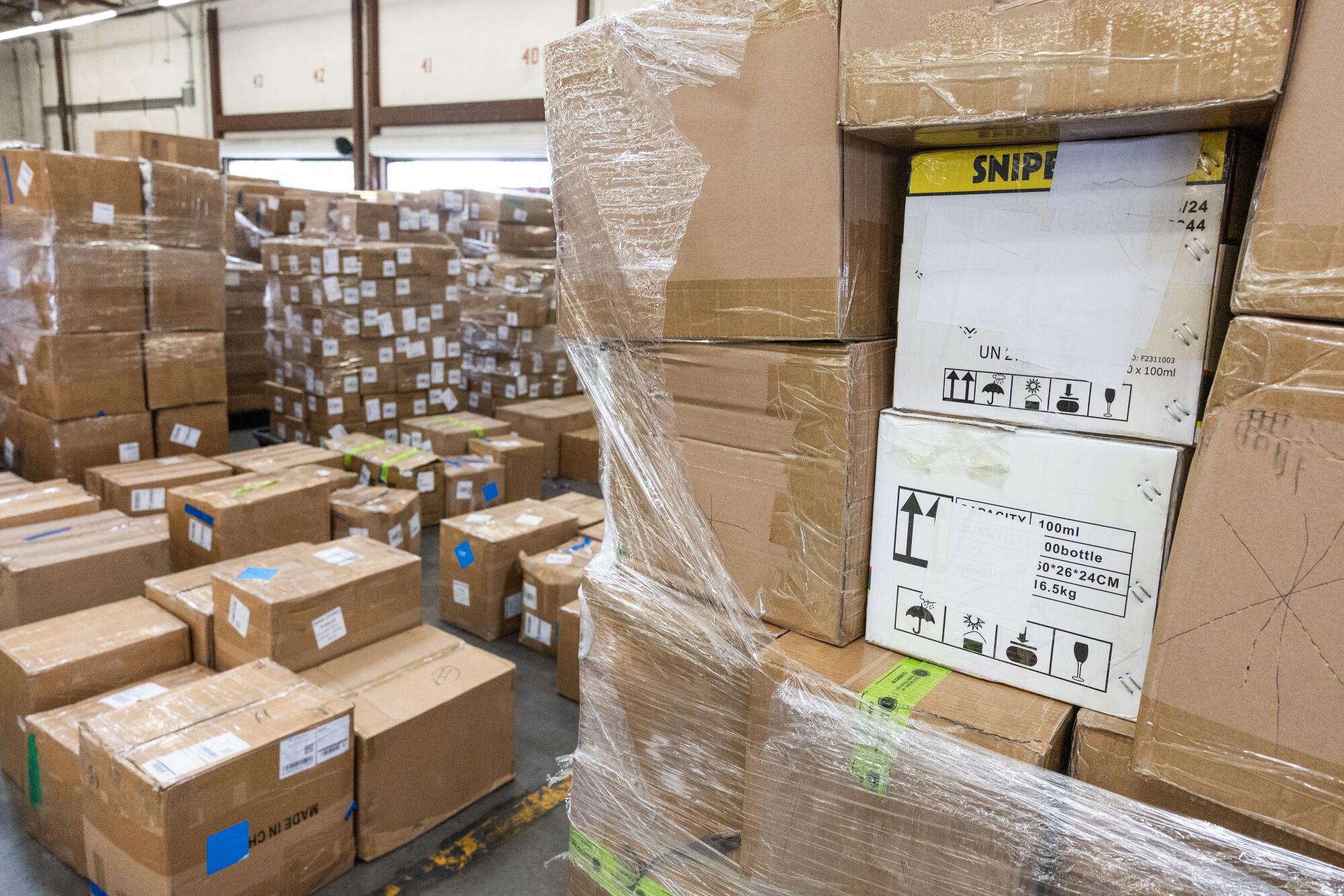 Stacks of brown cargo boxes, some shrink-wrapped