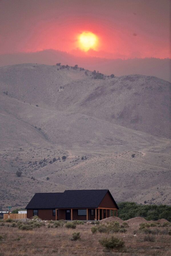 The sun sets over the Cottonwood Fire near Marysvale, Utah, on Friday, June 26, 2026. (AP Photo/Ty ONeil)