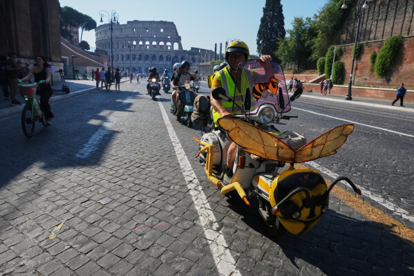 Vespa enthusiasts parade during celebrations for the 80th anniversary of the Vespa scooter, in Rome, Saturday, June 27, 2026. (AP Photo/Alessandra Tarantino)