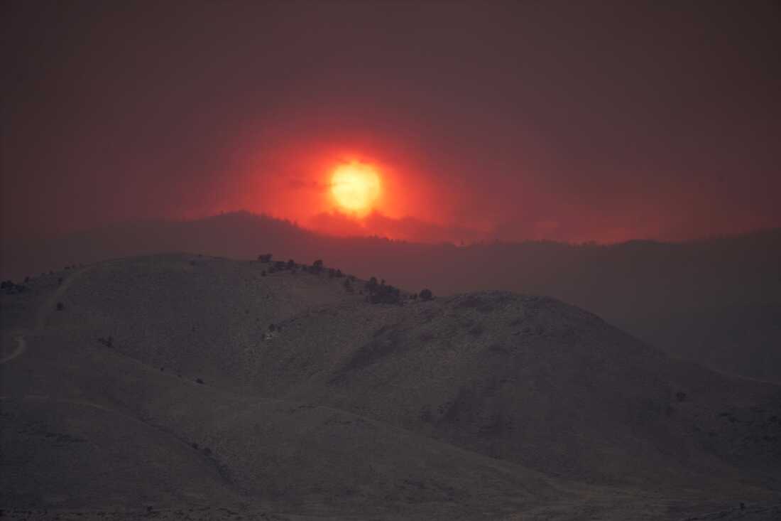 The sun sets over the Cottonwood Fire near Marysvale, Utah, on Friday, June 26, 2026.