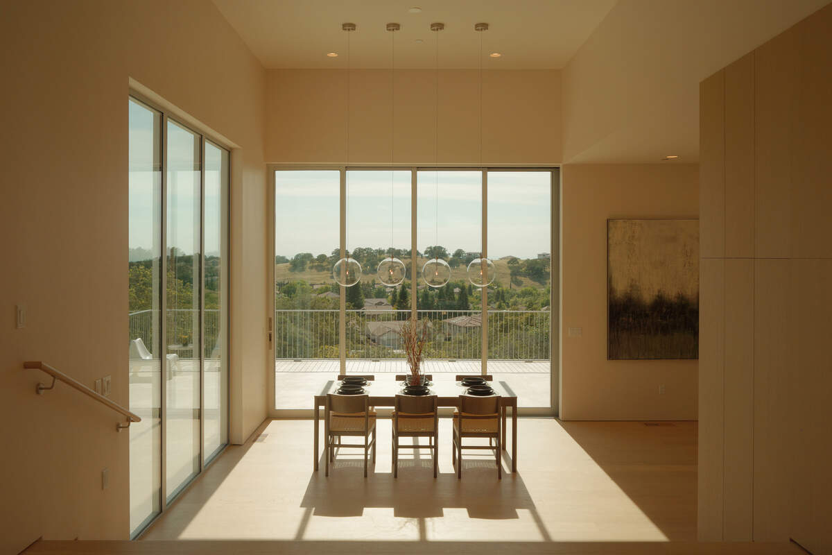 Inside, the home’s progression starts at the front door with what architects often call “compression and release” — an entry that holds back before it opens wide into the rest of the interior.