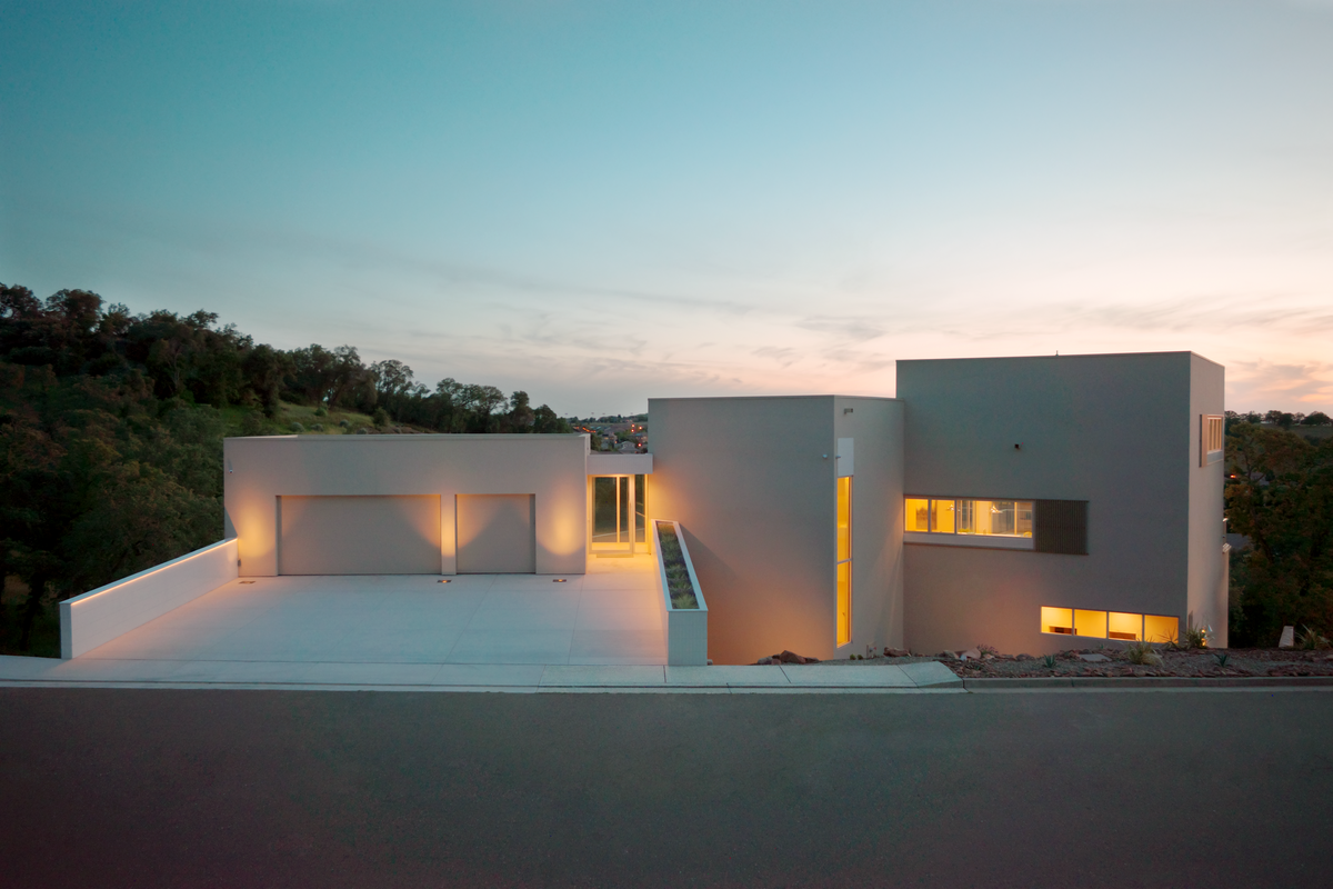 From the front, the residence at 1022 Via Treviso in El Dorado Hills offers a clean, contemporary façade, crisp horizontal lines and a single dominant color with subtle tile accents — modern but not busy.