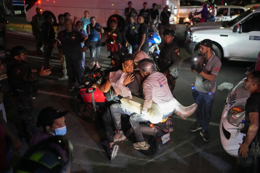 A youth rescued from the debris is taken away on a motorcycle two days after earthquakes struck La Guaira, Venezuela, Friday, June 26, 2026.