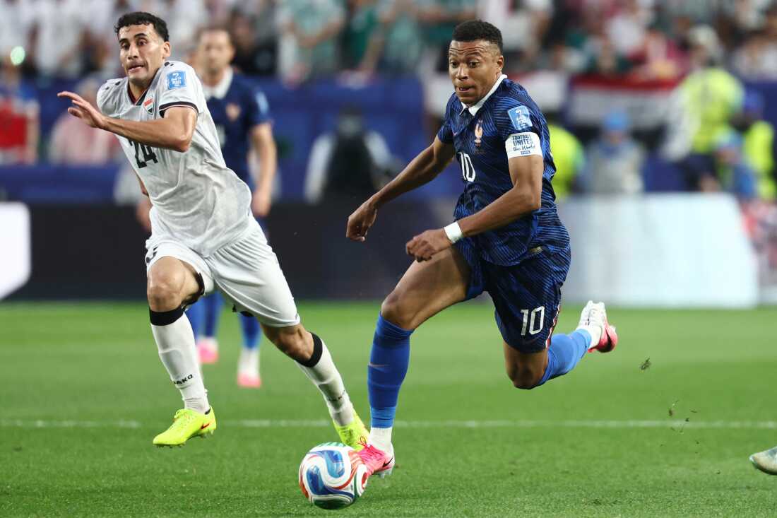 France forward Kylian Mbappé (r) runs with the ball past Iraq's midfielder Zaid Ismael during a World Cup Group I match in Philadelphia on June 22, 2026.