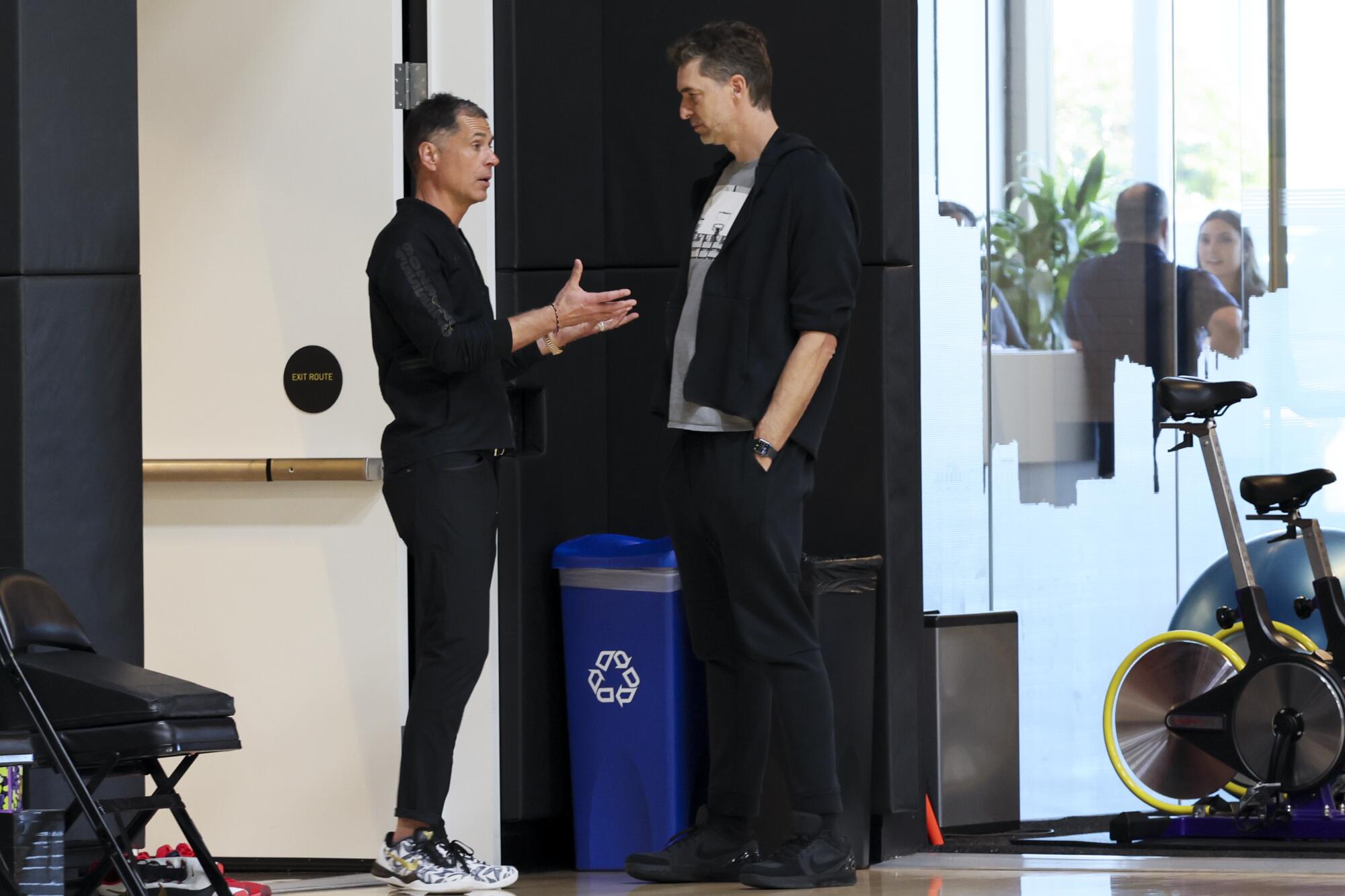 Former Laker Pau Gasol, right, speaks with GM Rob Pelinka during a Lakers practice in 2025.