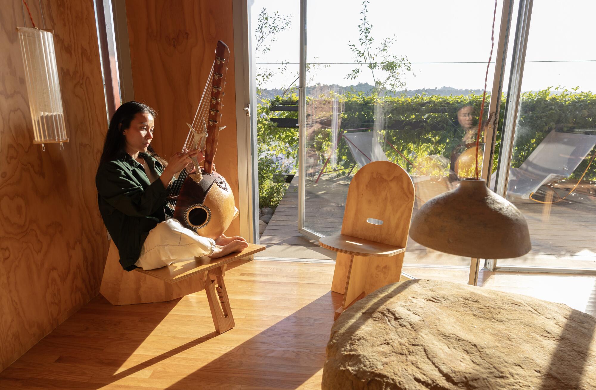 Li with an ngoni made by artist Layv in her music room.