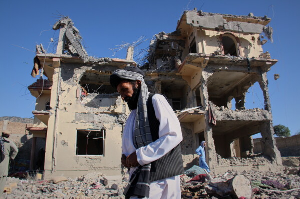 Residents walk through the rubble after what Taliban officials said were Pakistani airstrikes a day earlier that killed civilians, including children, in the village of Mandokhail, Chamkani district, Paktia province, Afghanistan, Monday, June 29, 2026. (AP Photo/Saifullah Zahir)