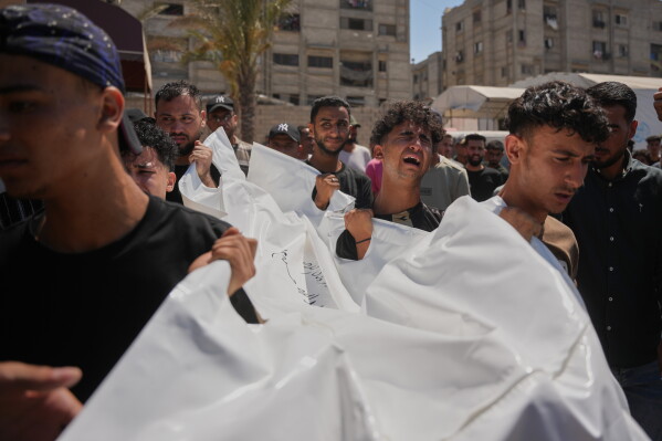Mourners carry the body of Palestinian Abdullah Moussa, 30, who was killed in an Israeli airstrike, during his funeral in Khan Younis, southern Gaza Strip, Saturday, June 27, 2026. (AP Photo/Abdel Kareem Hana)