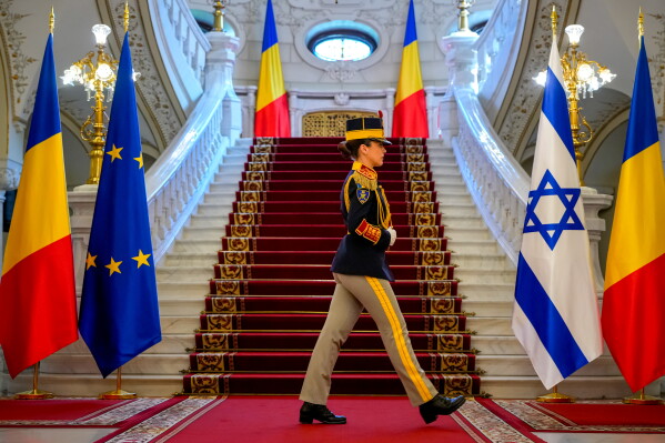 An honour guard soldier walks to her position before a welcoming ceremony for Israel's President Isaac Herzog, at the Cotroceni Presidential Palace in Bucharest, Romania, Monday, June 29, 2026. (AP Photo/Vadim Ghirda)