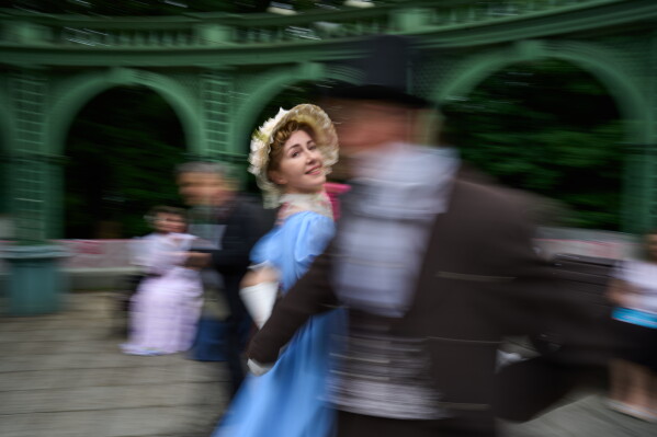 Reenactors dance during a festival at the Ostankino estates celebrating the 19th century art and culture in Moscow, Russia, Saturday, June 27, 2026. (AP Photo/Alexander Zemlianichenko)