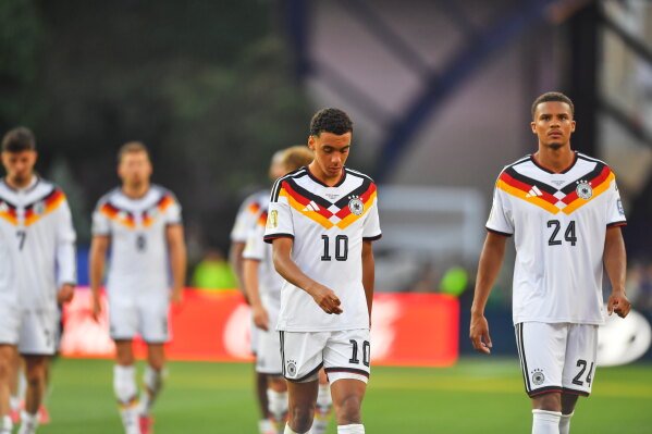 Germany's Jamal Musiala (10) and Malick Thiaw (24) walk off the field after losing to Paraguay in a shootout during the World Cup round of 32 soccer match in Foxborough, Mass., near Boston, Monday, June 29, 2026. (AP Photo/Steven Senne)