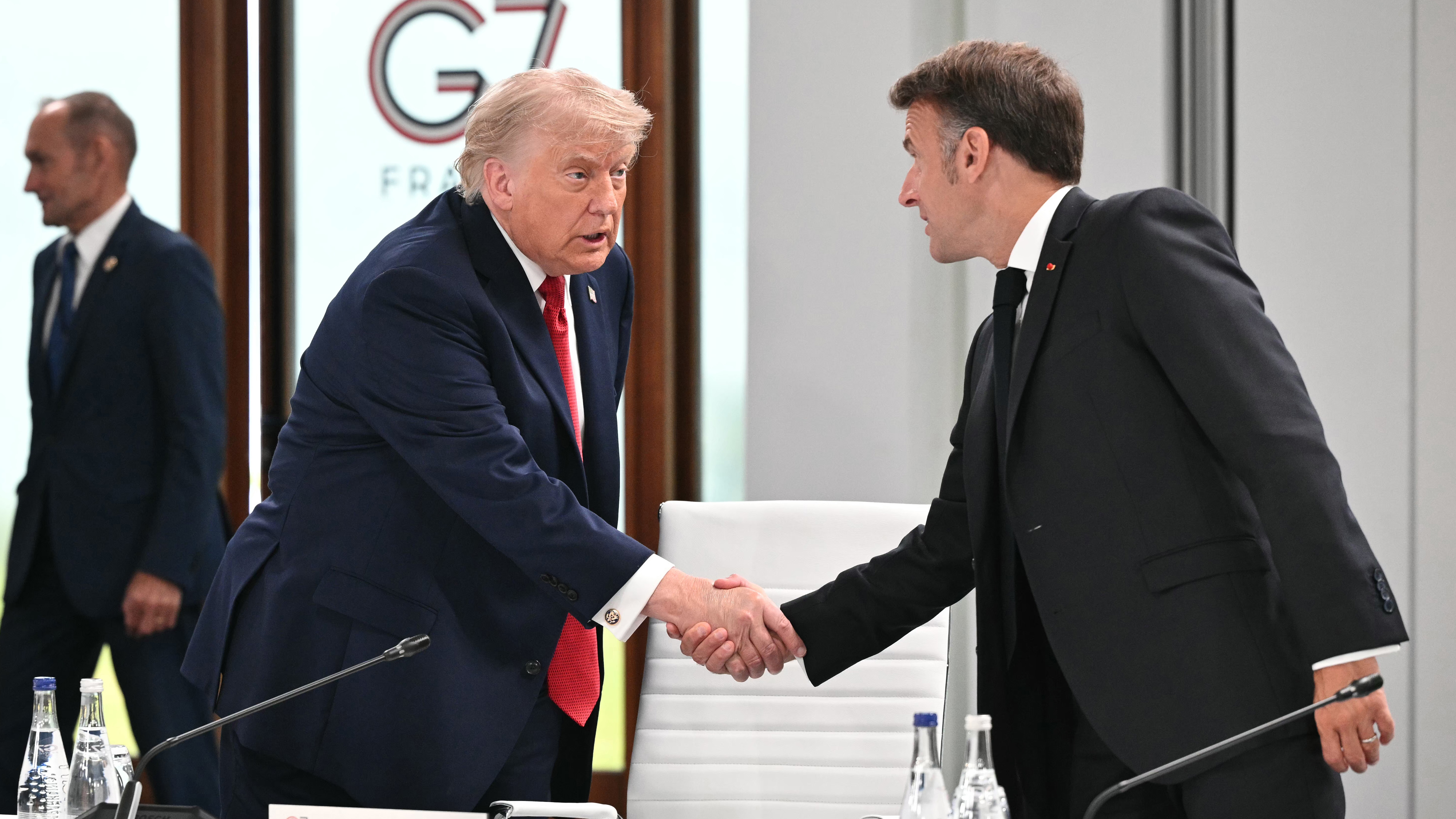 President Donald Trump, left, shakes hands with France's President Emmanuel Macron as they attend a working session at the G7 summit, in Evian-les-Bains, France, Wednesday, June 17, 2026.