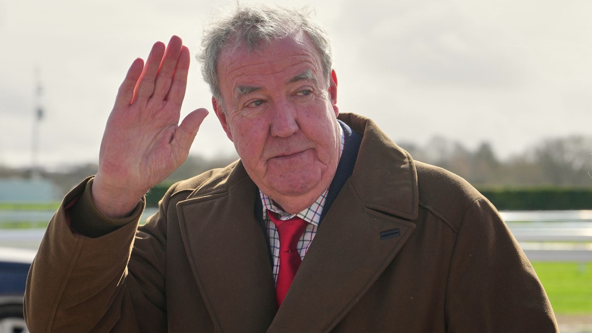 FILE - TV presenter Jeremy Clarkson waves to the media as he arrives on day four of the 2026 Cheltenham Festival in Cheltenham, England, on March 13, 2026.