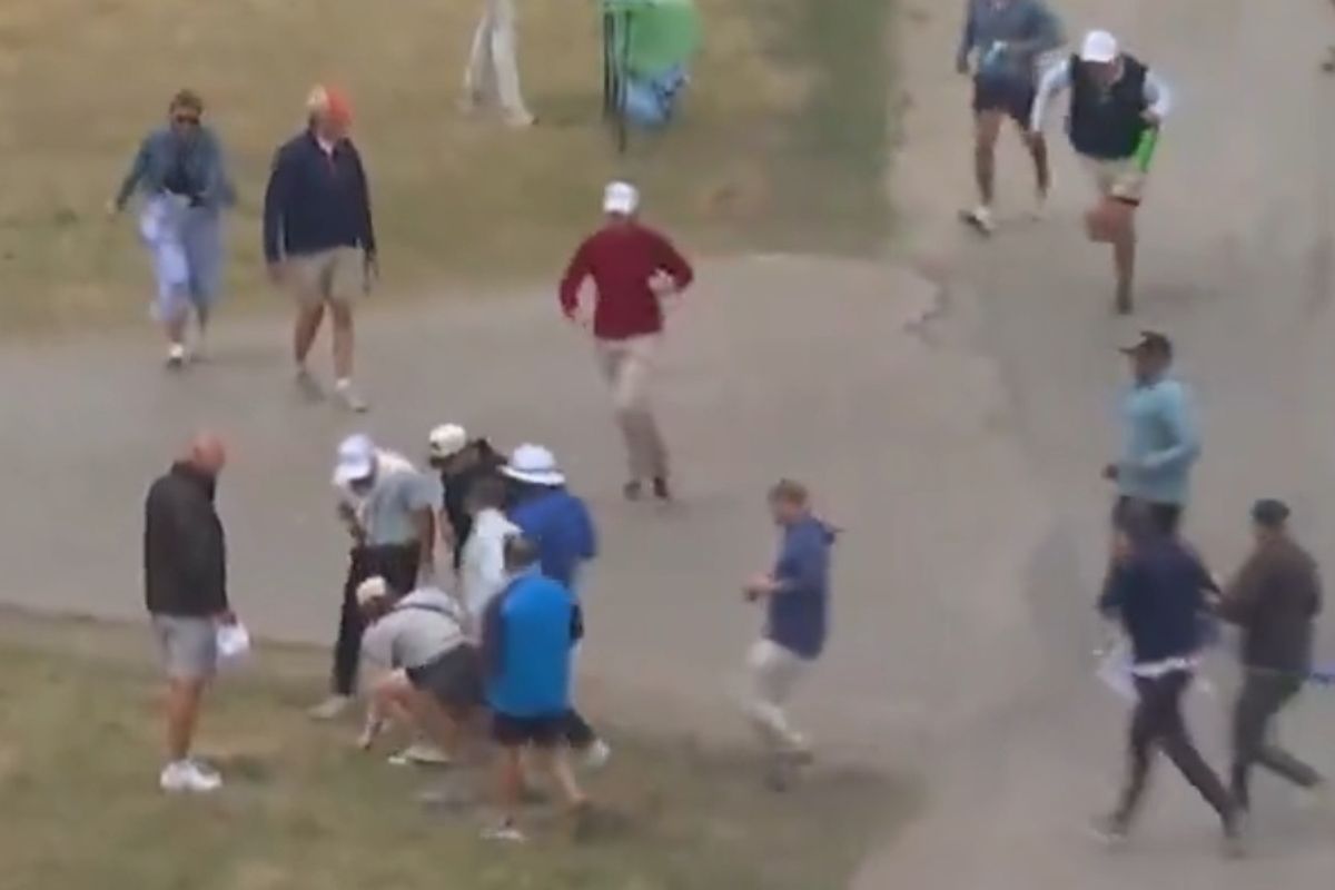 A fan approaches Rory McIlroy's ball