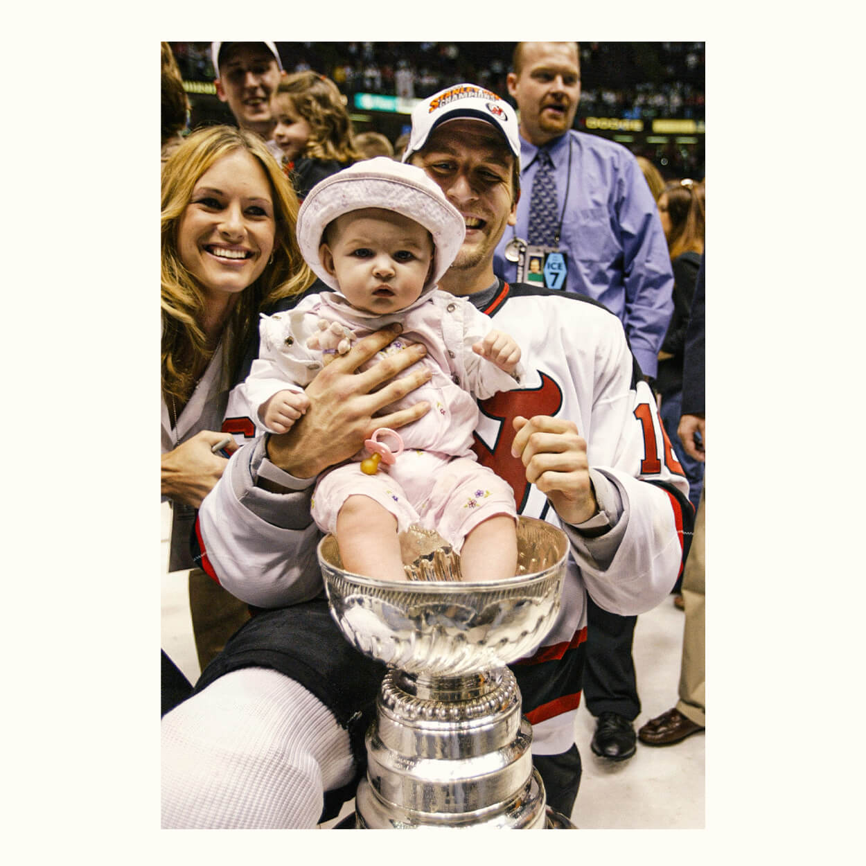Mike Rupp holds his daughter Maddie in Cup after the Devils' clincher in 2003.