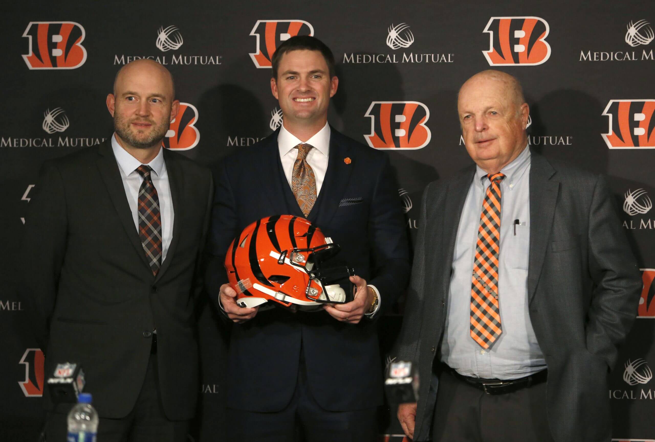 Cincinnati Bengals head football coach Zac Taylor (middle) poses for photo alongside Bengals owner Mike Brown (right) and Duke Tobin , Bengals director of player personnel at the end of a press conference at Paul Brown Stadium.