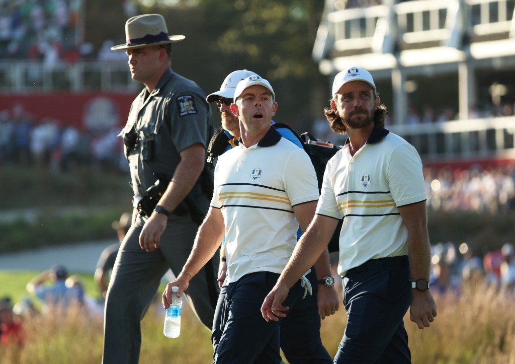 Team Europe's Tommy Fleetwood and Rory McIlroy walk during singles play at the 2025 Ryder Cup.