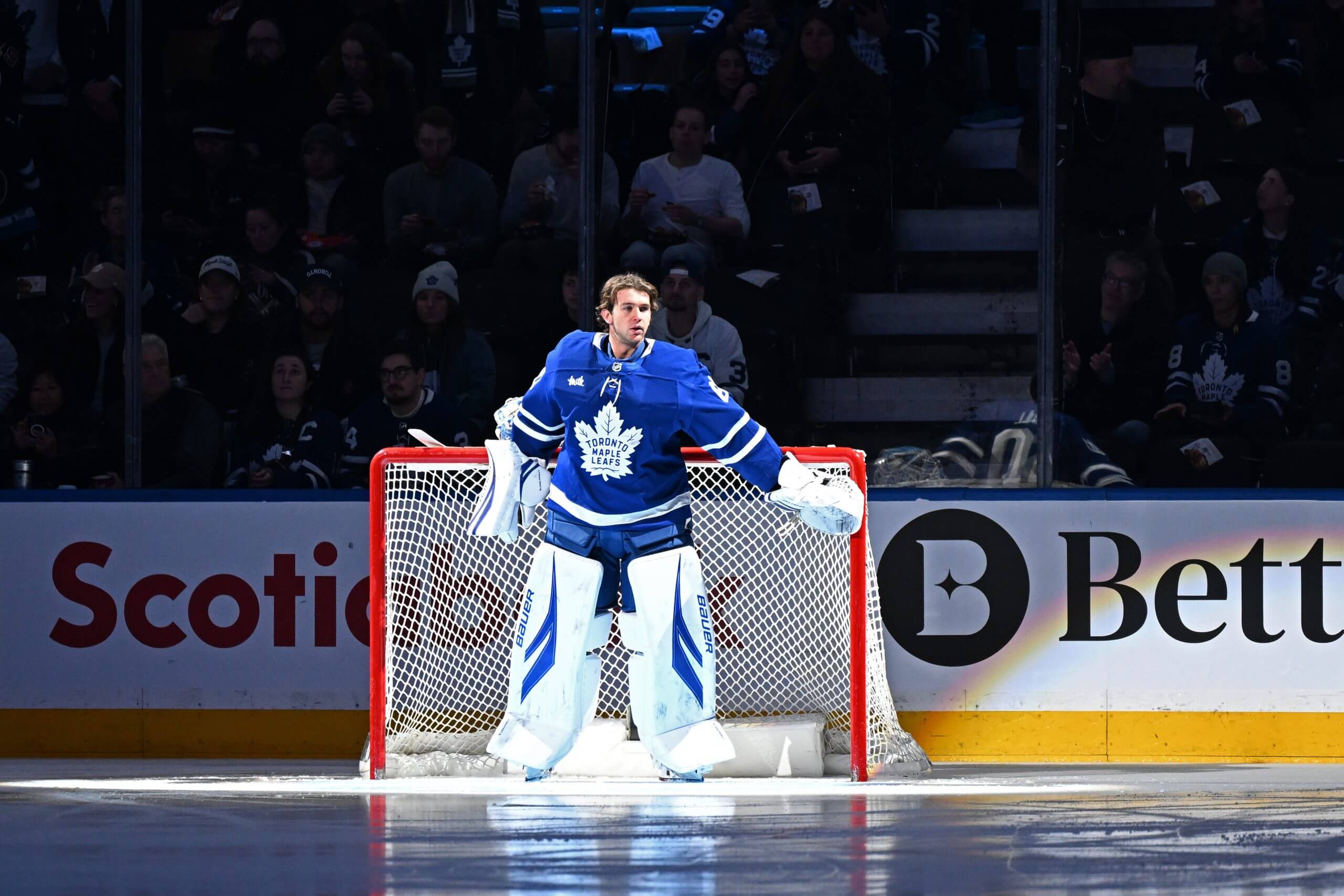Goalie Joseph Woll pats the goalposts before a Leafs game.