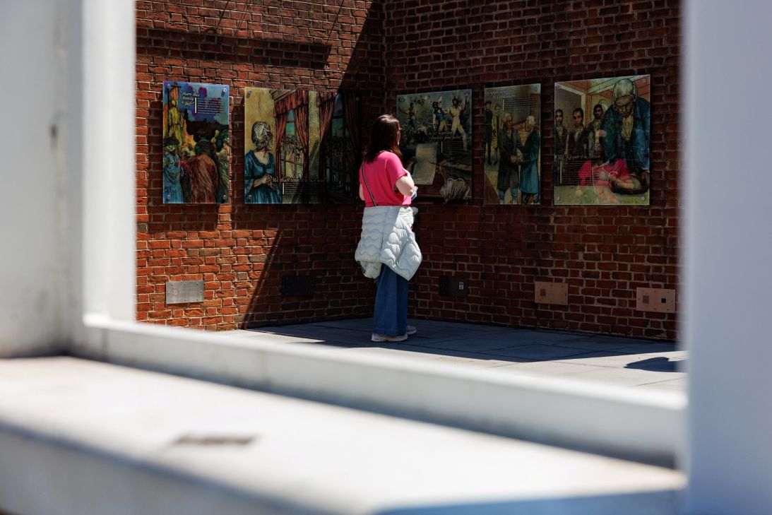 A person looks on at a slavery exhibit that was partially reinstalled at the President's House in Philadelphia on May 1.