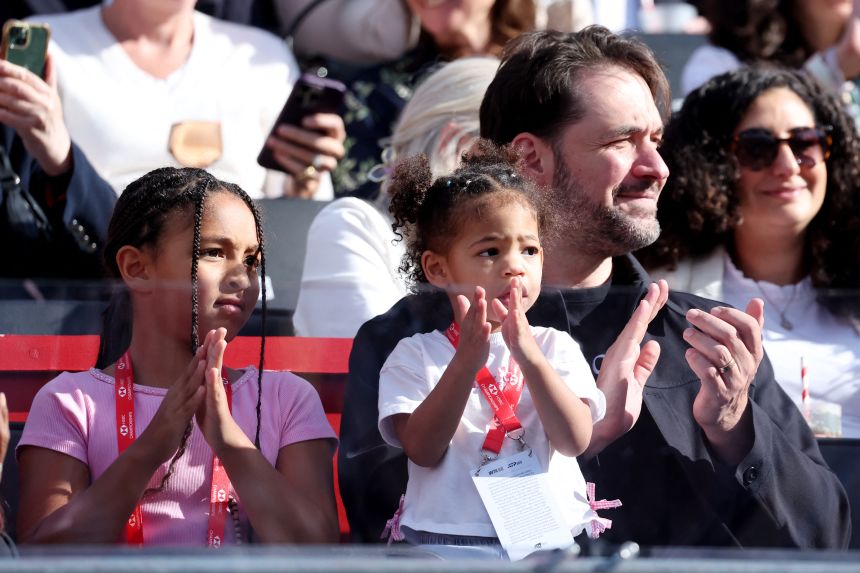 Serena Williams' husband, Alexis Ohanian, watches his wife's match along with their children, Olympia and Adira.