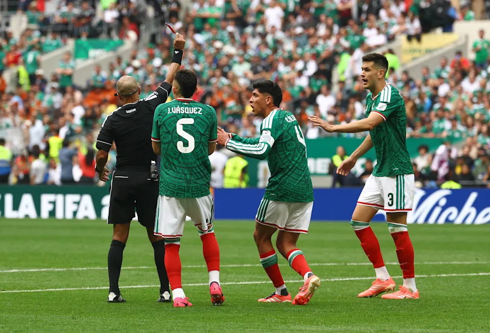 Mexico's players protest after Montes was given a red card.