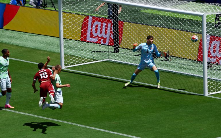 Qatar's Boualem Khoukhi scores their first goal past Switzerland's Gregor Kobel