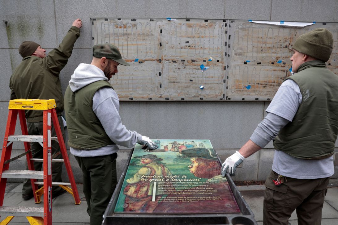 Workers from the National Park Service reinstall a slavery exhibit at a historic site in Philadelphia following a judge's order to reinstall it as seen on February 19.
