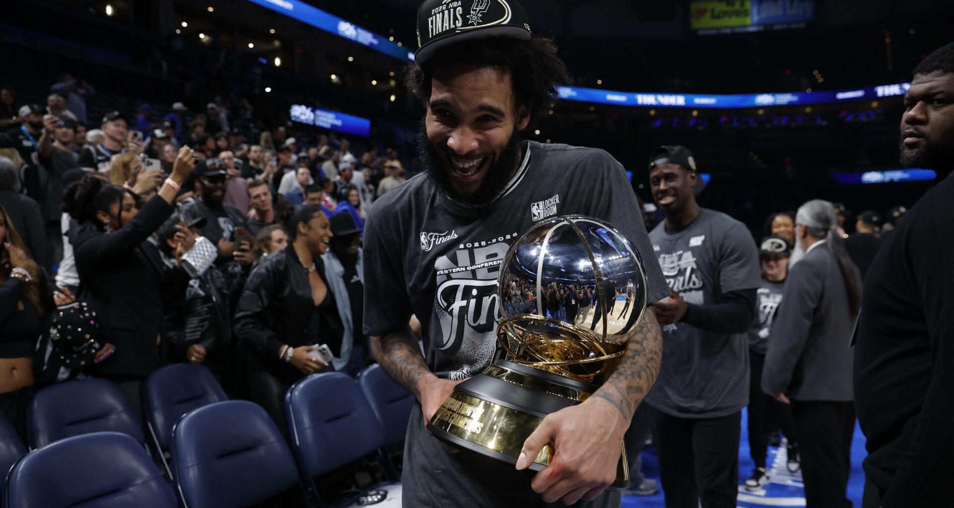 Julian Champagnie holds the NBA Western Conference Finals trophy