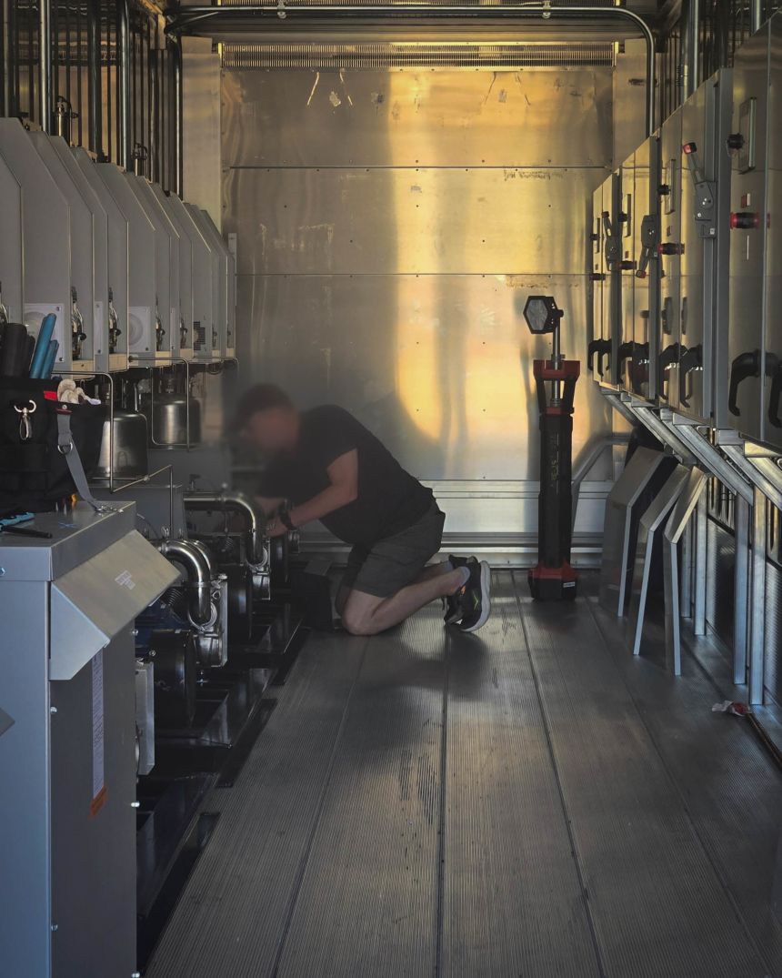 A Greenwater Services worker inside the Reflecting Pool pump house working the nanobubble technology system.