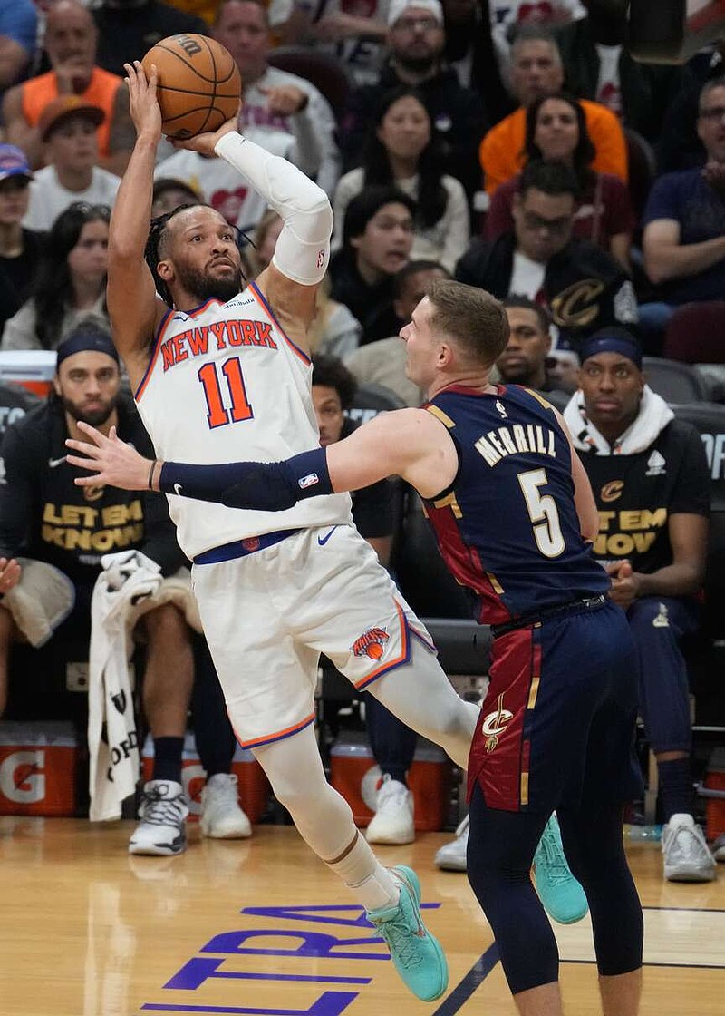 New York Knicks guard Jalen Brunson (11) shoots against Cleveland Cavaliers guard Sam Merrill (5) during the second half of Game 4 in the Eastern Conference finals NBA basketball playoffs series in Cleveland, Monday, May 25, 2026. (AP Photo/Sue Ogrocki)