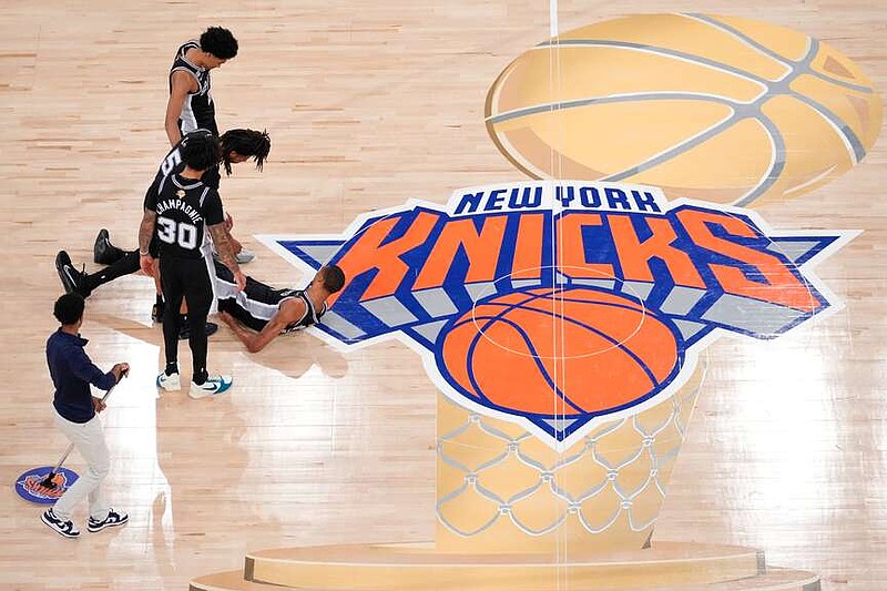 San Antonio Spurs guard Stephon Castle (5) helps up forward Victor Wembanyama (1) after being hit during the second half of Game 3 of the NBA Finals basketball series, Monday, June 8, 2026, in New York. (AP Photo/Yuki Iwamura)