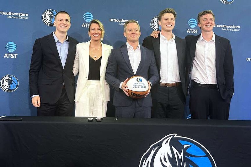 New Dallas Mavericks coach Dusty May, center, poses with his family, from left to right, son Eli May, wife Anna May, son Jack May and son Charlie May, during Dusty's introductory NBA basketball news conference in Dallas, Monday, June 29, 2026. (AP Photo/Schuyler Dixon)