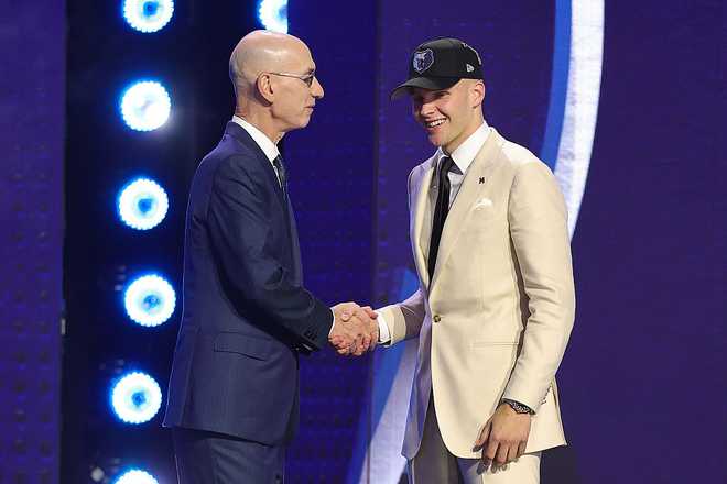 2026 NBA Draft - Round One NEW YORK, NEW YORK - JUNE 23: NBA commissioner Adam Silver shakes hands with Bennett Stirtz after he is drafted sixteenth overall by the Memphis Grizzlies during Round One of the 2026 NBA Draft at Barclays Center on June 23, 2026 in New York City. (Photo by Arturo Holmes/Getty Images)