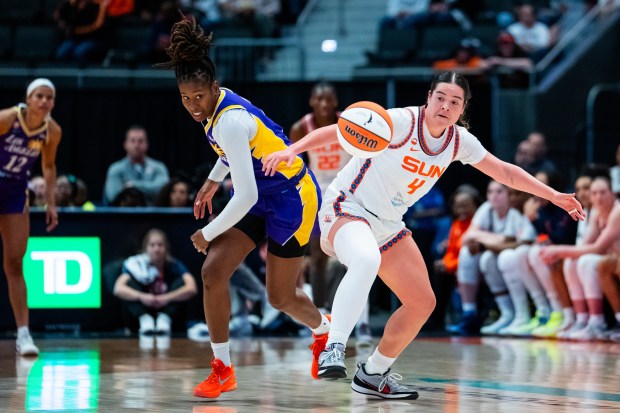 Ariel Atkins, left, of the Sparks and Charlisse Leger-Walker of the Sun go for the loose ball during the second half of a WNBA basketball game at PeoplesBank Arena on May 30, 2026 in Hartford. (Joe Buglewicz/Getty Images)