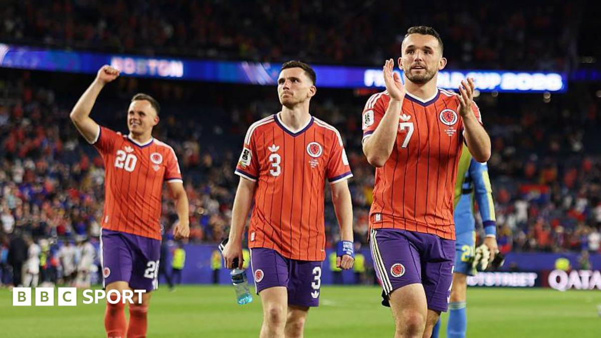 John McGinn, Andy Robertson and Lawrence Shankland salute the travelling Scotland fans