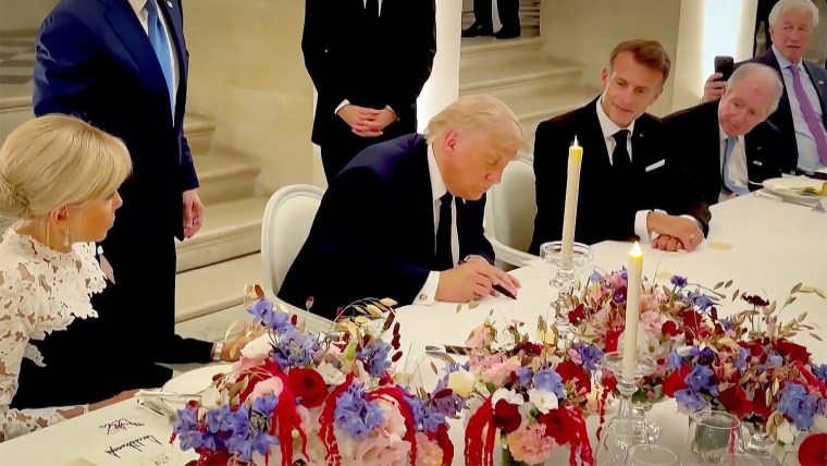 Donald Trump signs Iran deal at Versailles.