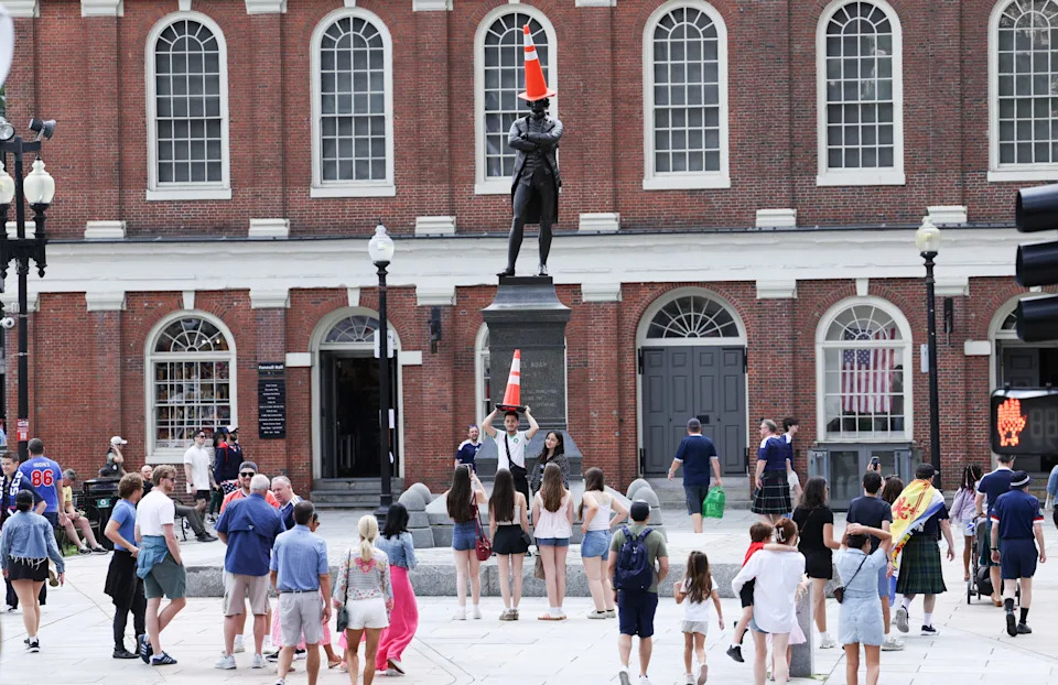 A statue of Samuel Adams with a traffic cone on his head is pictured in Boston.