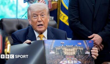 Donald Trump hols up a rendered image of the UFC's White House event