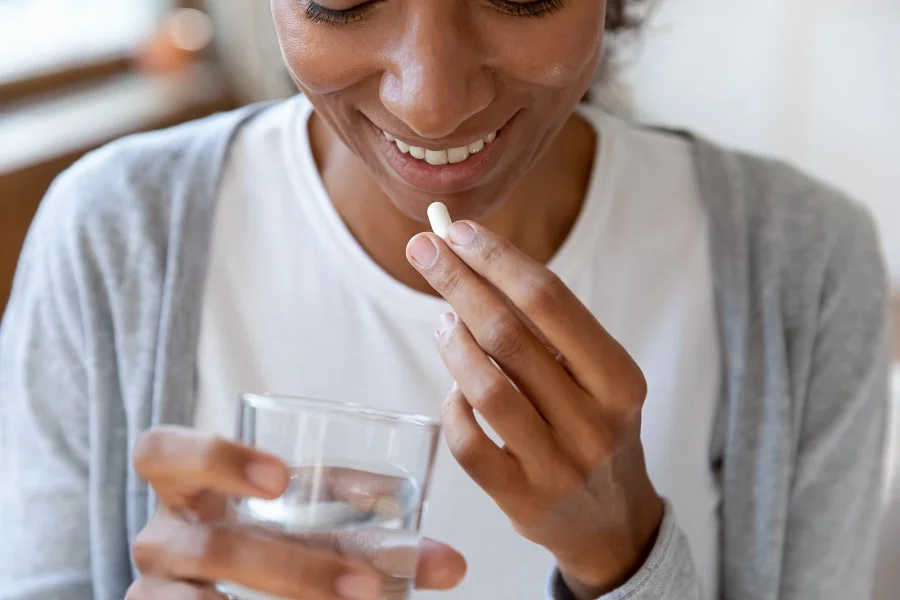 Woman taking fiber capsules